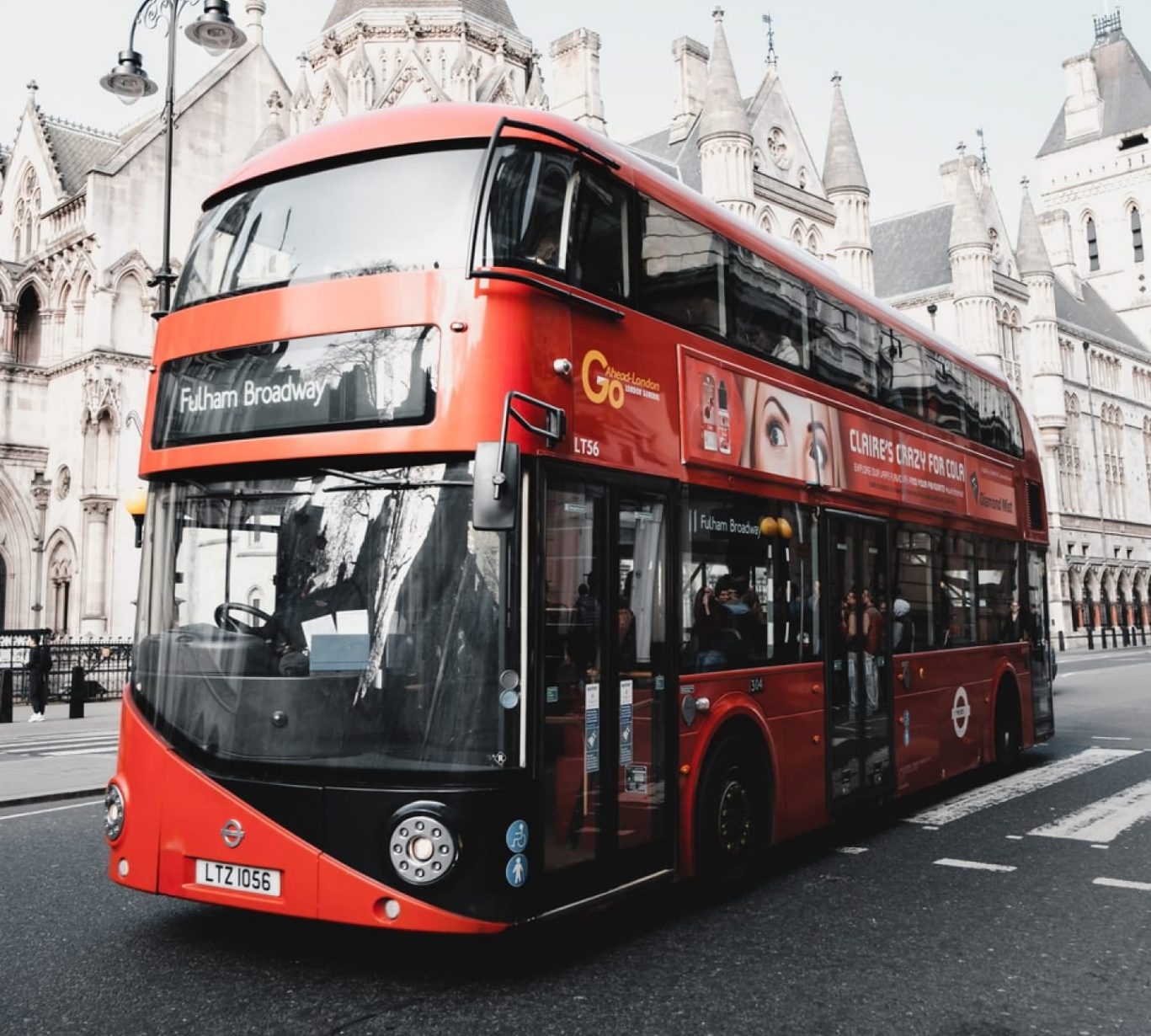 Red double decker bus driving through London
